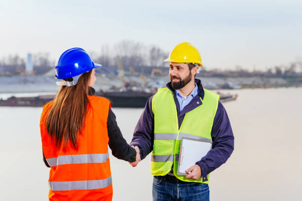 istock Teamwork in freight transportation industry - two engineers working together at the dock 645373570