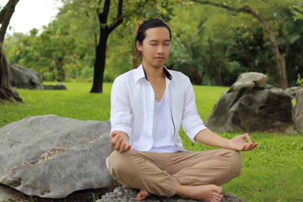 istock Yogi man doing yoga meditation while sitting in lotus position 645374152
