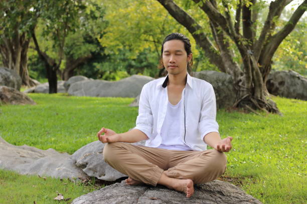 istock Yogi man doing yoga meditation while sitting in lotus position 645374946