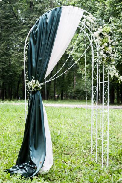 istock Wedding arch on the lawn in the park 645374998