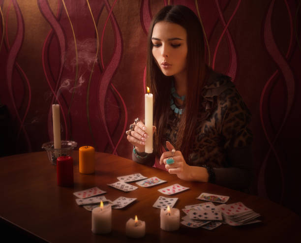 istock girl extinguishes candles after divination 645377302