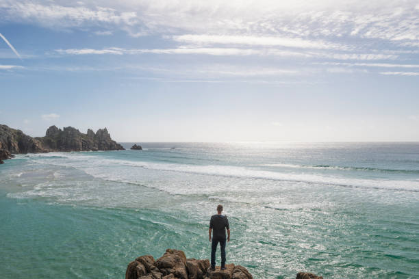 istock Man Stood overlooking Pedn Vounder Beach, South Cornwall 645377846