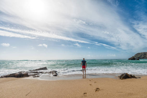 istock Man paddling at Pedn Vounder Beach, Cornwall 645377848