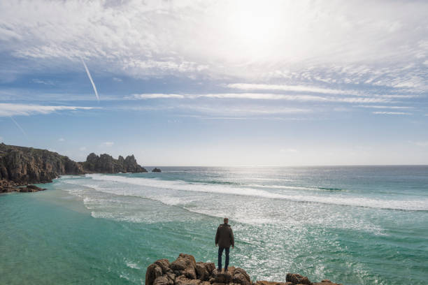 istock Man Stood overlooking Pedn Vounder Beach, South Cornwall 645377862