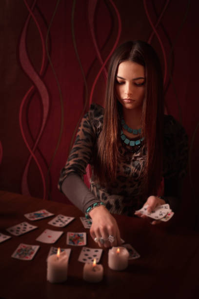 istock Young woman with divination cards in room 645378066