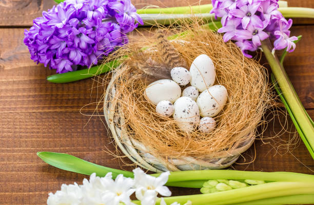 istock Beautiful Easter eggs with flowers hyacinths on the wooden background 645390696