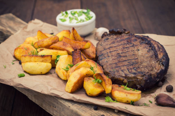 istock Rustic grilled beefsteak with french fries 645401212