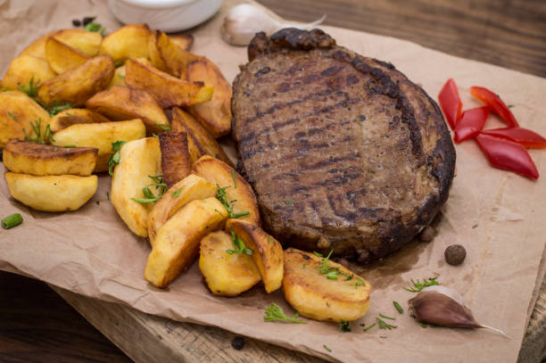 istock Rustic grilled beefsteak with french fries 645401240