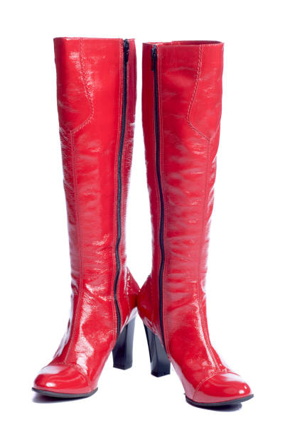 Red boots Red beautiful shining modern boots isolated on white red boot stock pictures, royalty-free photos & images