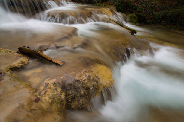 istock Pristine waterfalls deep in the woods, on a bright sunny day in spring 645422674