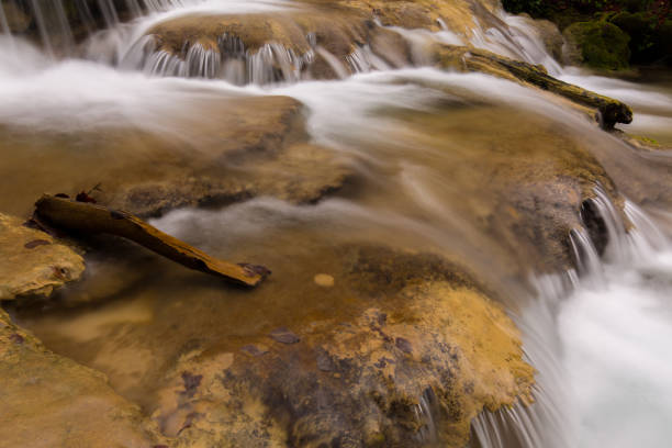istock Pristine waterfalls deep in the woods, on a bright sunny day in spring 645422688