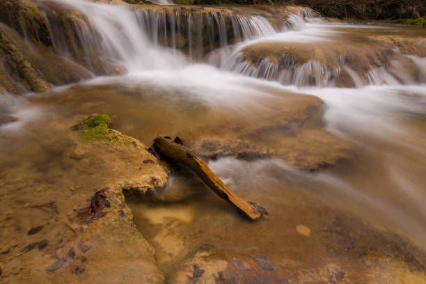 istock Pristine waterfalls deep in the woods, on a bright sunny day in spring 645422718