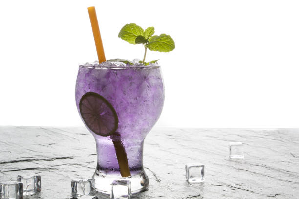 istock Purple soda lime drink with lime on stone. 645426678