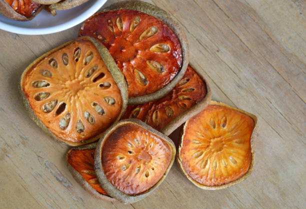 istock dried bael fruit on wooden board 645435322