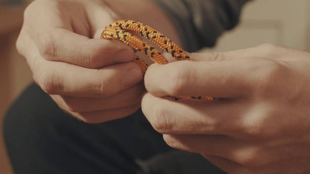 istock Man's hands tying a mountaineering knot on a rope 645439684