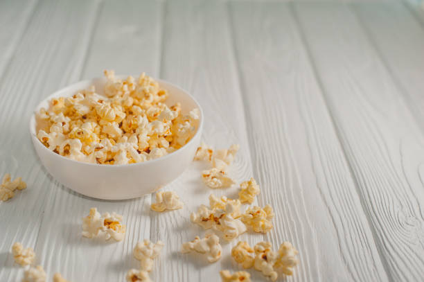 istock popcorn on a white wooden background 645439696