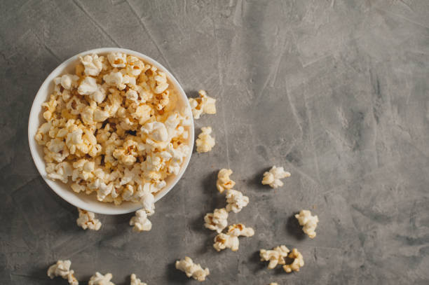 istock popcorn in a white plate on a concrete gray background 645439698