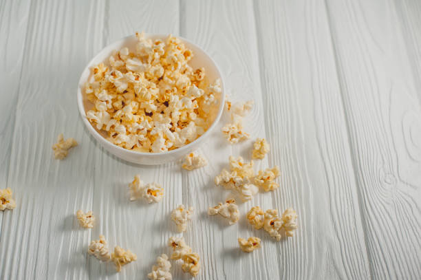 istock popcorn on a white wooden background 645439702