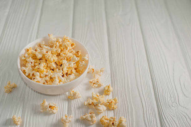 istock popcorn on a white wooden background 645439704