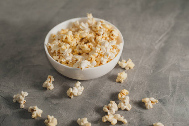 istock popcorn in a white plate on a concrete gray background 645439706
