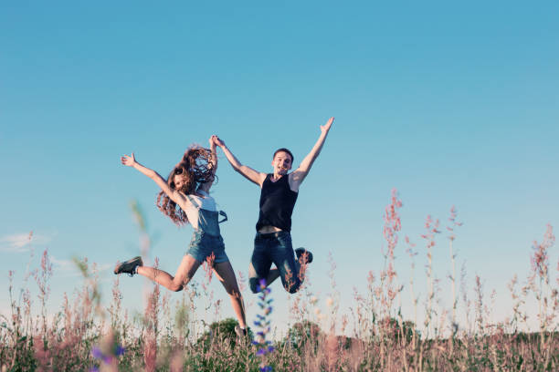 istock Young happy couple jumping outdoor 645439984