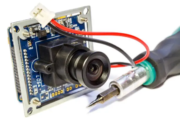 Photo of Electronic module with lens for surveillance camera and screwdriver
