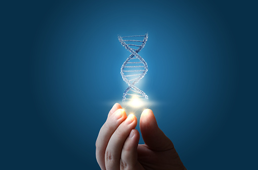 ADN en mano sobre fondo azul. photo