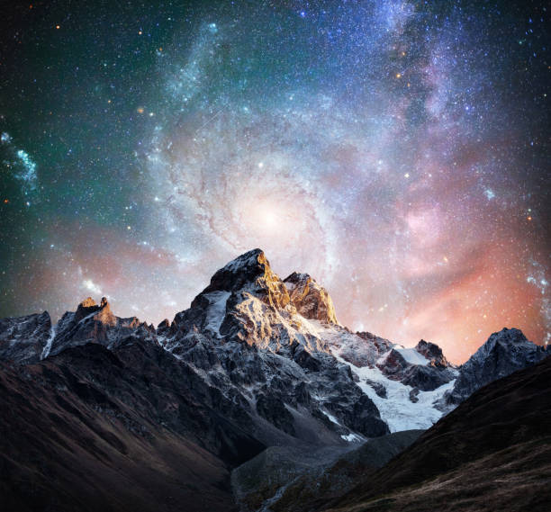 istock Fantastic starry sky. Snow-capped peaks. Main Caucasian Ridge. C 645462720