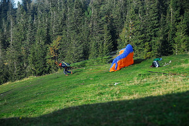 Person Launching Parachute On Field