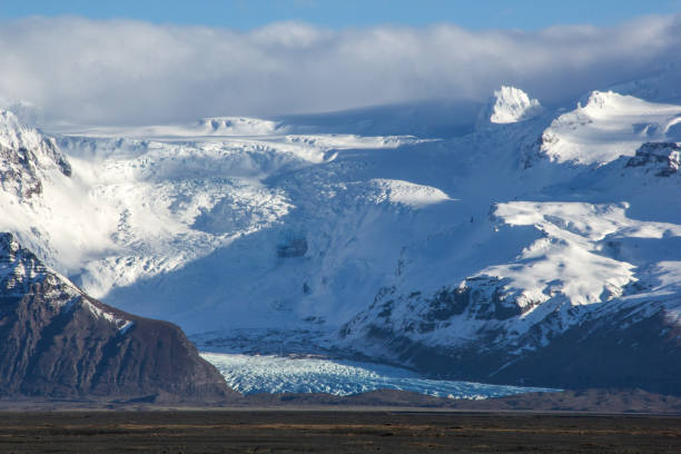 istock Blue glacier between snowed mountains, South Iceland 645466174