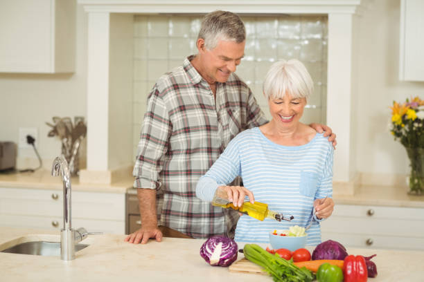 istock Senior couple preparing vegetable salad 645466192