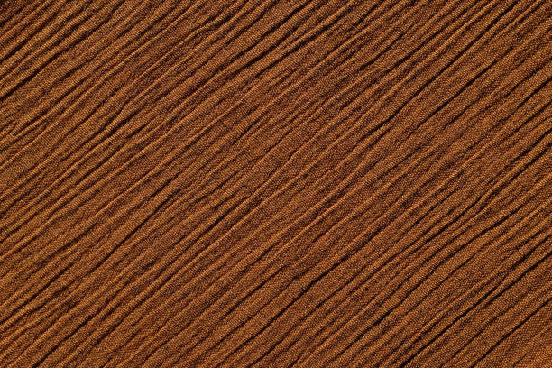 istock Warm brown crinkled fabric background texture 645474910