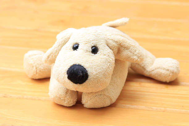 istock Doll Dog brown on a wooden background 645474916