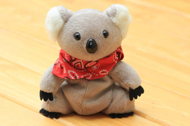 Doll koala bare on a wooden background