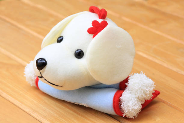 istock Doll Dog white on a wooden background 645475068