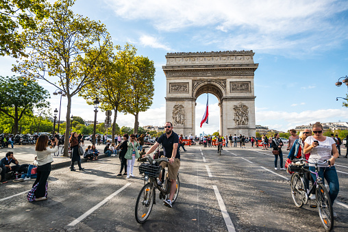 Paris, France - September 25, 2016: Car Free Day in Paris. Champs-Elysees Quartier and many neighbor streets closed for all traffic and open for pedestrians and cyclists. People walking and cycling on famous Avenue des Champs-Elysees free of usual heavy traffic.
