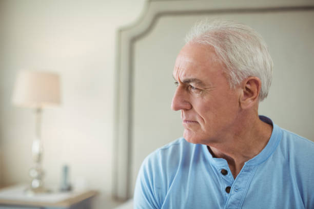 istock Thoughtful senior man sitting in bed room 645478740