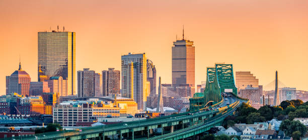 Boston skyline panorama Tobin bridge, Zakim bridge and Boston skyline panorama at sunset. boston massachusetts stock pictures, royalty-free photos & images