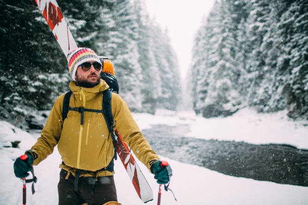 man with ski walking in the snow forest stock photo