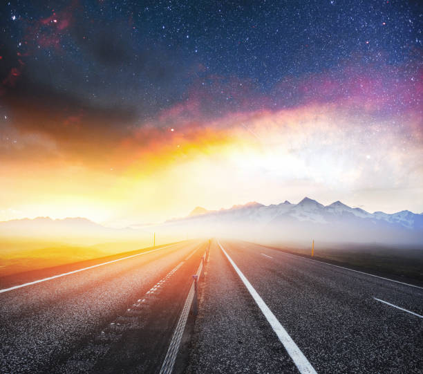 istock Starry Sky over the mountains. The asphalt road with white marki 645488198