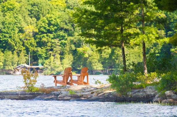 istock Wood Muskoka chairs facing a lake 645488250