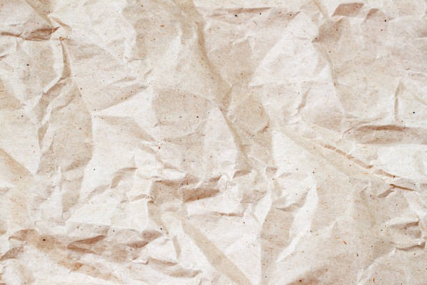 istock Rumpled environmental or craft paper texture background close-up. Grunge old paper surface texture. For modern pattern, wallpaper, banner design. Place for your text 645491924