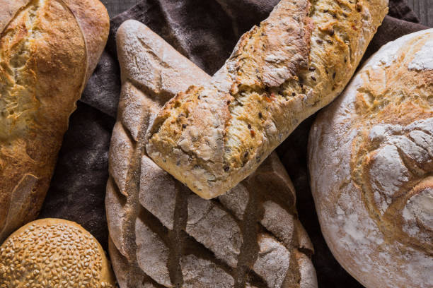 istock Several types of fresh bread lying on an old wooden table 645492086