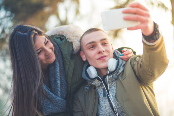 istock Funny young couple taking selfies 645495016
