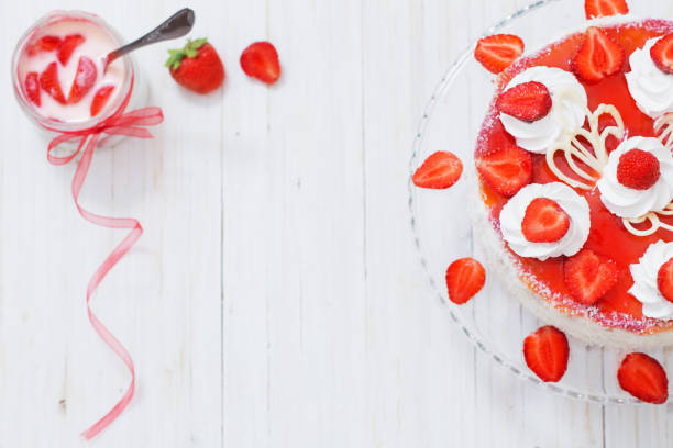 istock cake with strawberries on white wooden table 645495462
