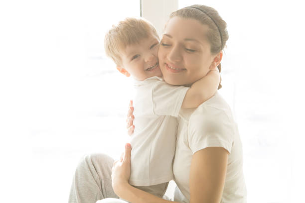 istock Beautiful mother and her cute son embrace 645495798