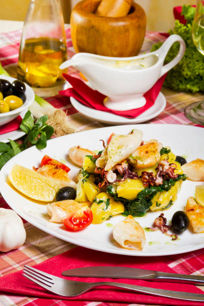 istock Grilled Calamari Boiled Potatoes Chard Lemon and Cherry Tomatoes 645496334