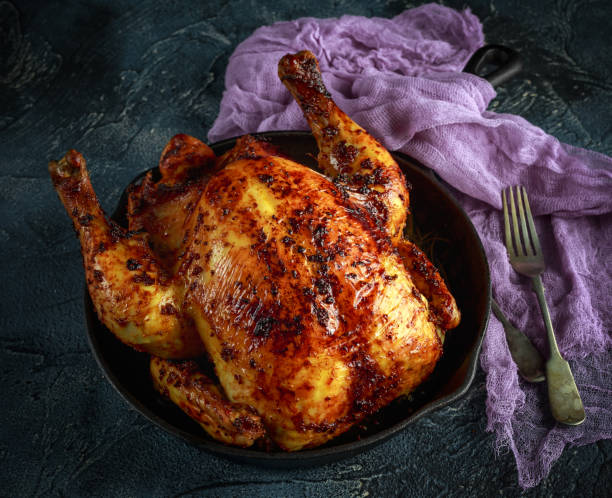 istock Organic cornfed free range oven baked chicken in rustic pan with lemon slices and rosmary 645499372