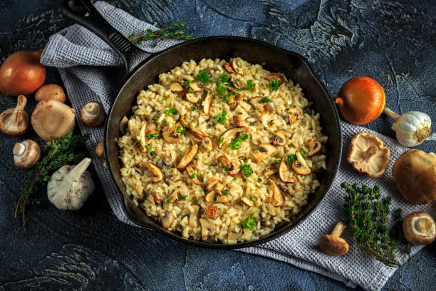 istock Mushroom Risotto in iron pan with herbs and parmesan cheese 645499654