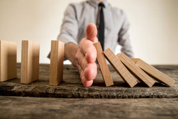 istock Businessman halting the domino effect 645502684